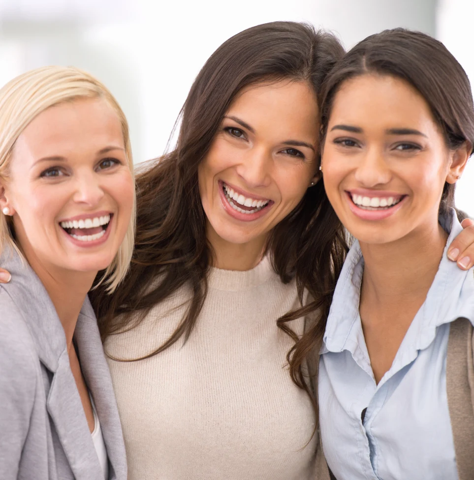 three women are smiling together